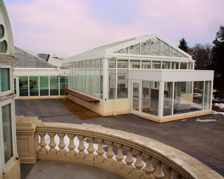 New pavilion with growing houses in background and historic conservatory in foreground